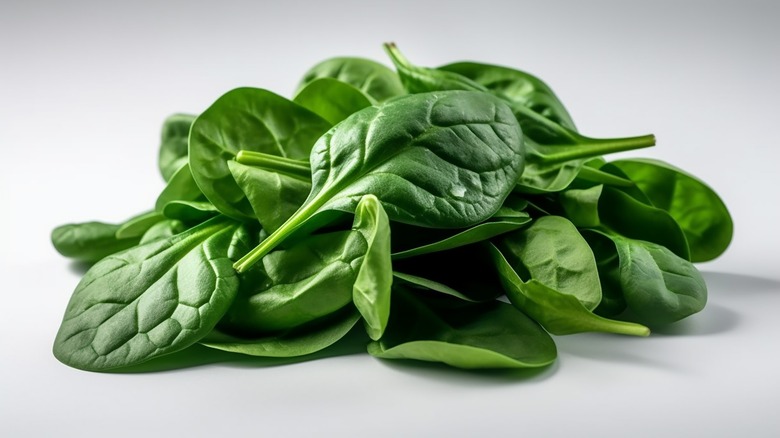 Pile of spinach on white background