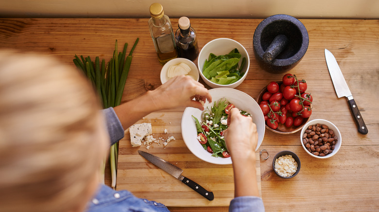 Person assembling salad