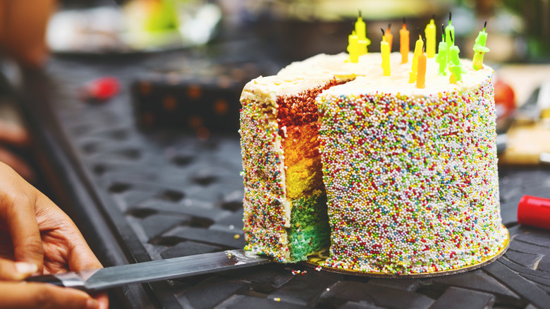 Cutting a rainbow cake