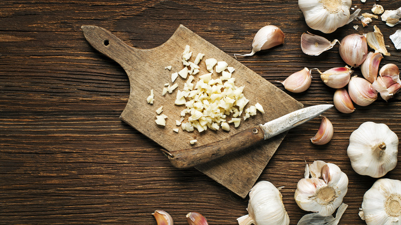 chopped garlic cloves on board