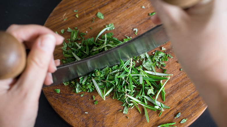 chopping herbs on cutting board