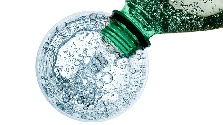 top view of sparkling water pouring into glass