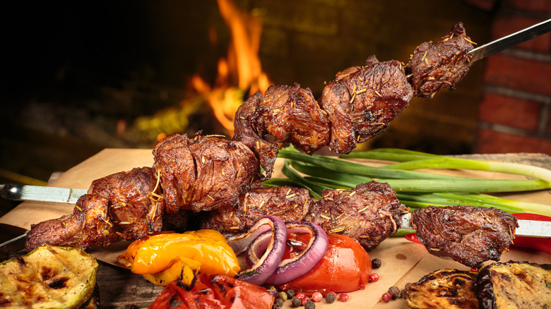 Close-up of grilled kebabs and vegetables