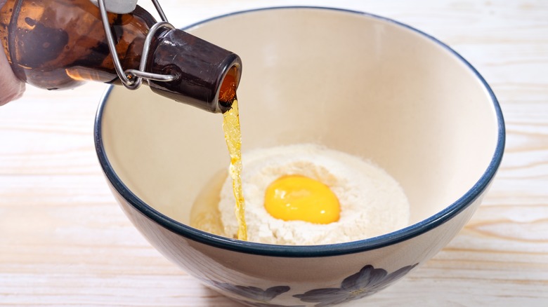 Pouring beer into crepe ingredients