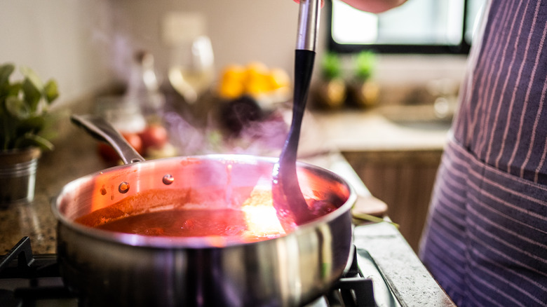 cooking pasta sauce in saucepan