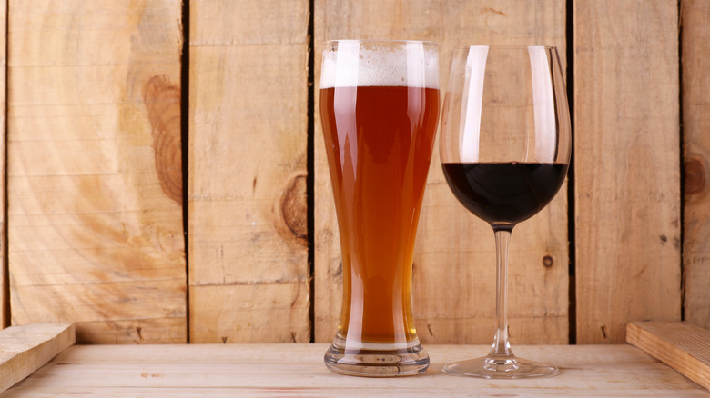 Glass of wine next to glass of beer