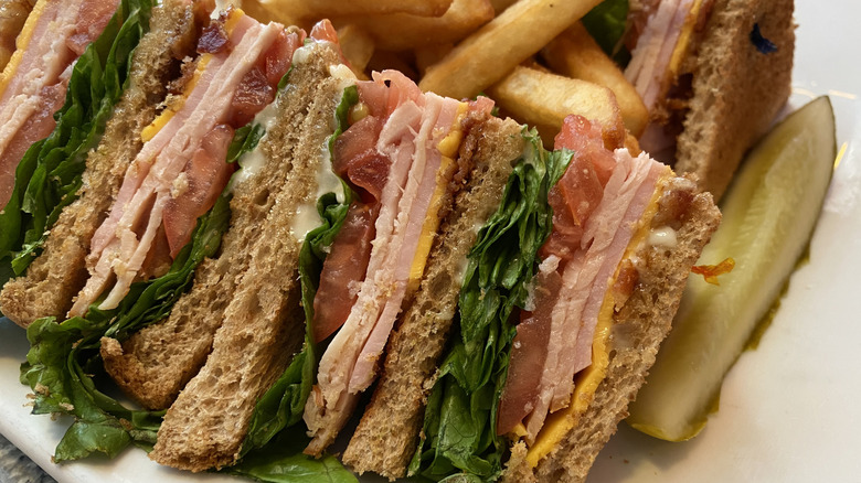 Side view of club sandwich with pickle spear