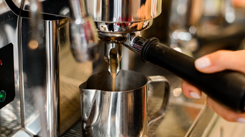 Person pouring a shot of espresso