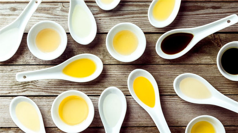 Various oils in spoons and bowls 