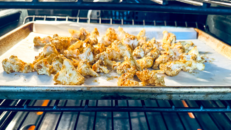 tray with cauliflower in oven