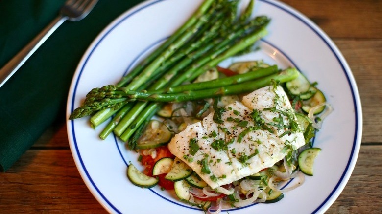 haddock with vegetables on plate