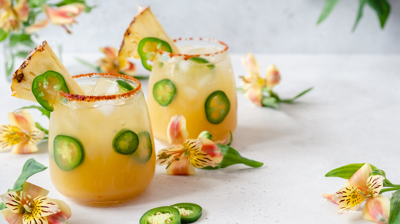 Pineapple jalapeño margaritas flowers white table