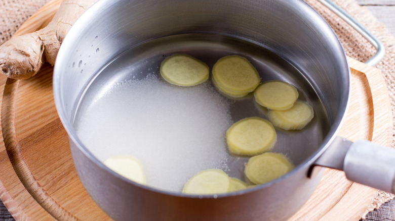 Ginger slices in pan of water