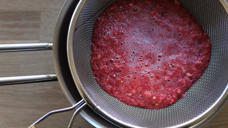 Pomegranate juice in a strainer