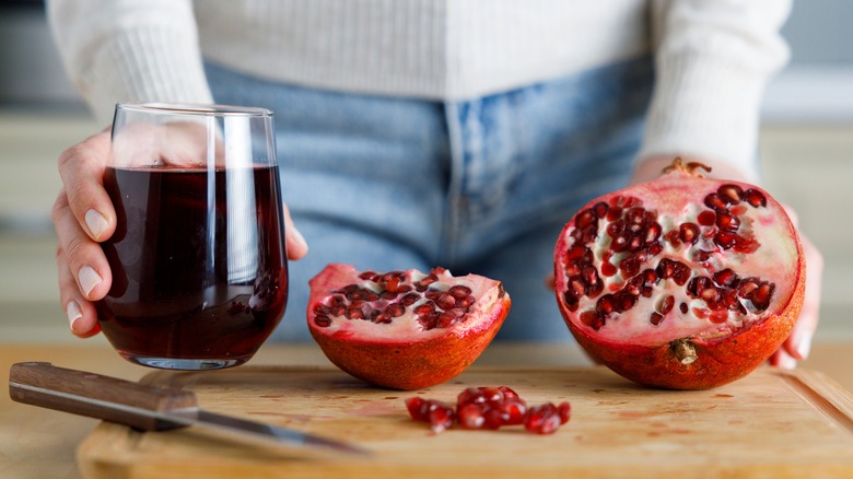 Woman holding pomegranate and juice