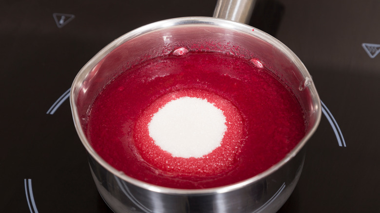 Pomegranate juice and sugar in pot