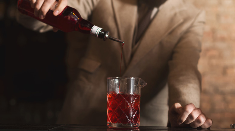 Grenadine pouring in mixing glass