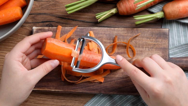 Peeling carrot on a cutting board