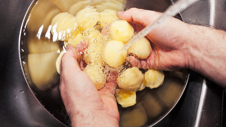 Washing potatoes in a bowl
