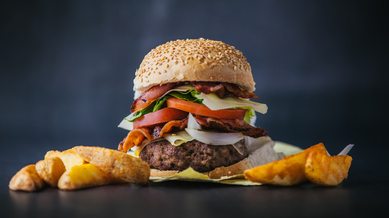 burger overloaded with toppings and condiments