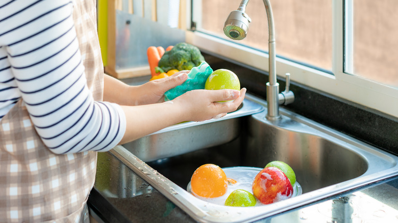 Woman scrubbing apples