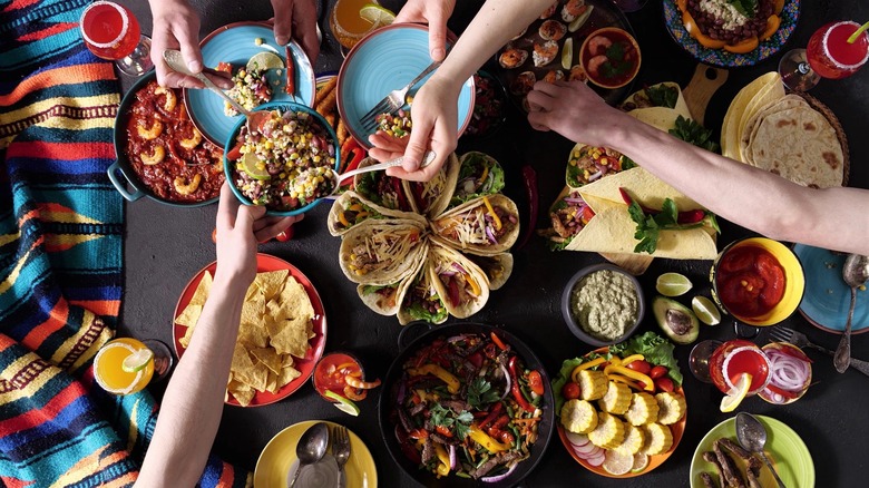 People share plates at dinner party