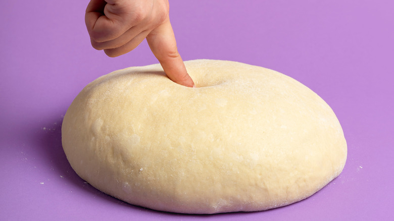 Finger poking dough ball