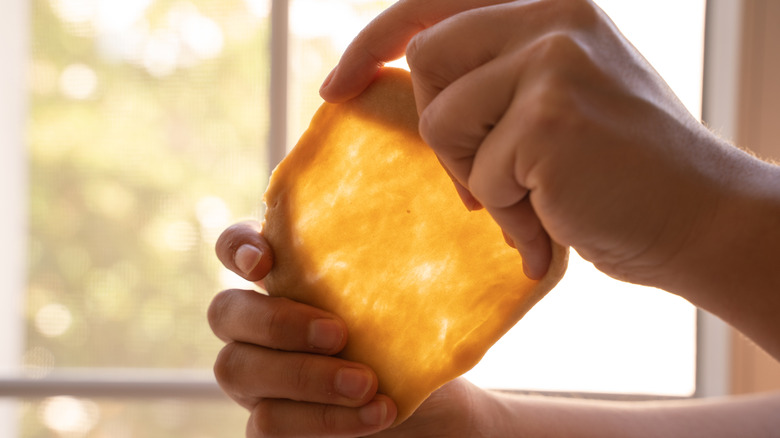 Baker stretching dough