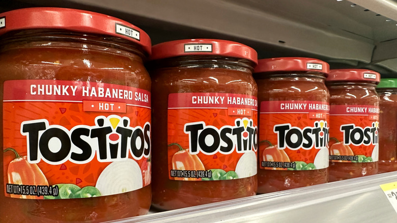 Jars of Tostito's salsa on a grocery store shelf