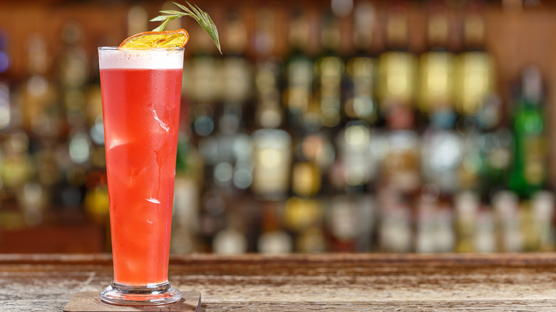 Singapore sling against bar backdrop