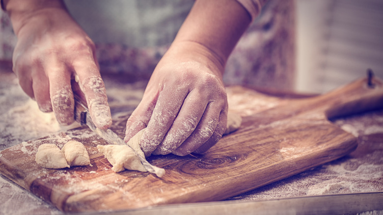 Hands making gnocchi