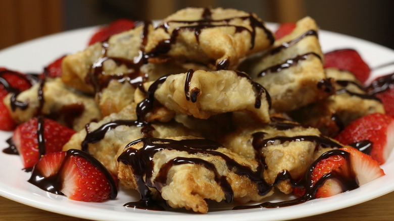 chocolate drizzled over fried wontons with strawberries