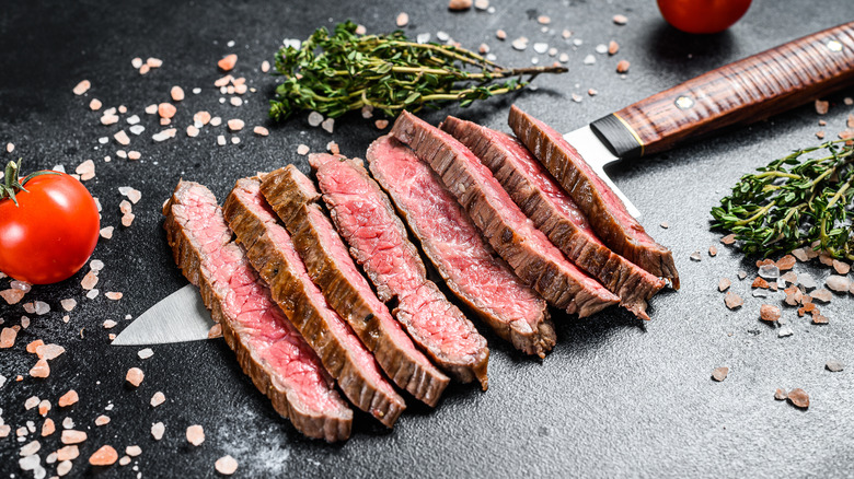 Rare sliced steak on knife