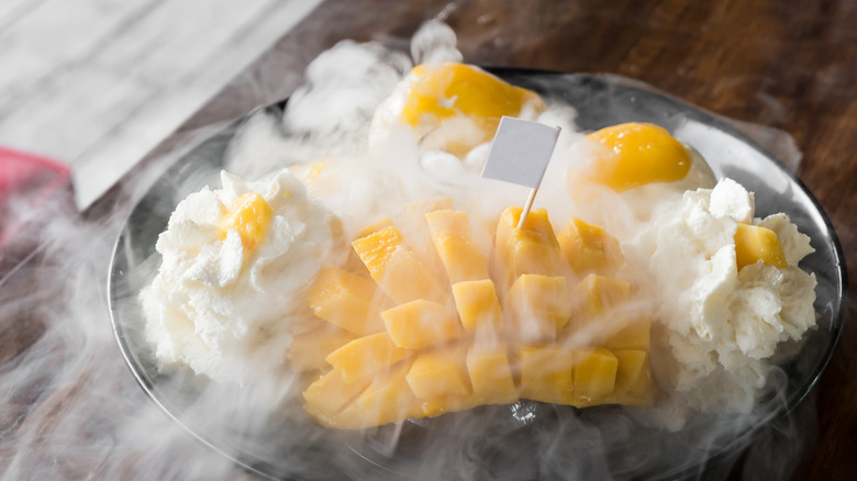 bowl of smoking ice cream with mango in it