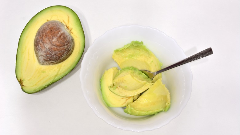 avocado scooped out with spoon