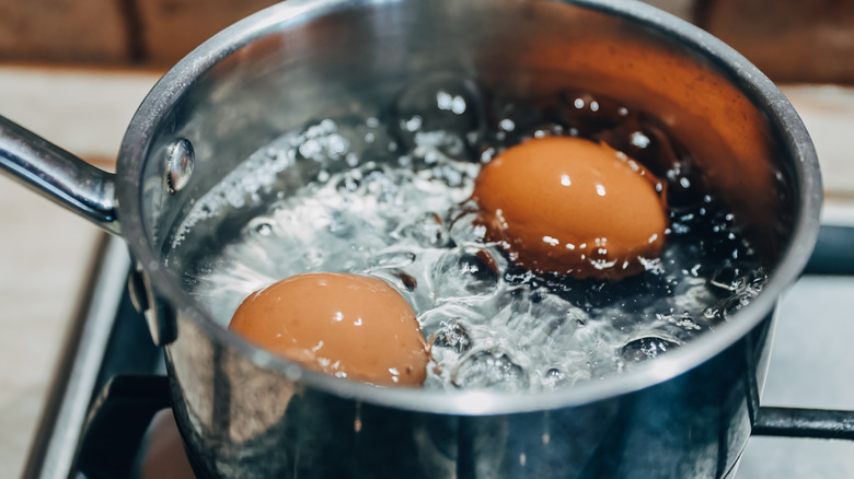 eggs being boiled in pot of water