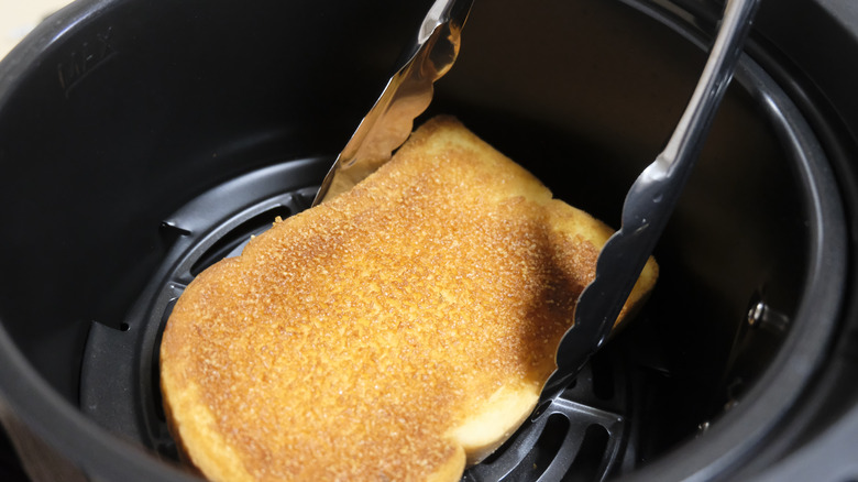 Bread going into air fryer interior