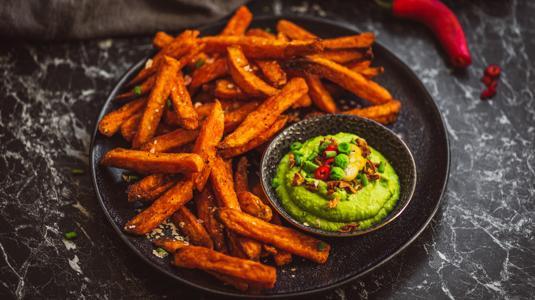 sweet potato fries on plate with guacamole