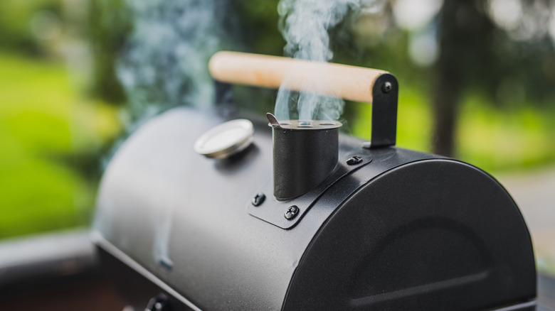 Outdoor grill with smoke