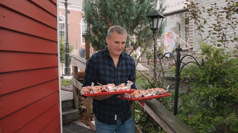 Phil Rosenthal holding lobster rolls