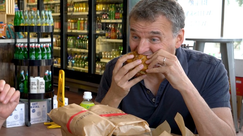 Phil Rosenthal eats a sandwich