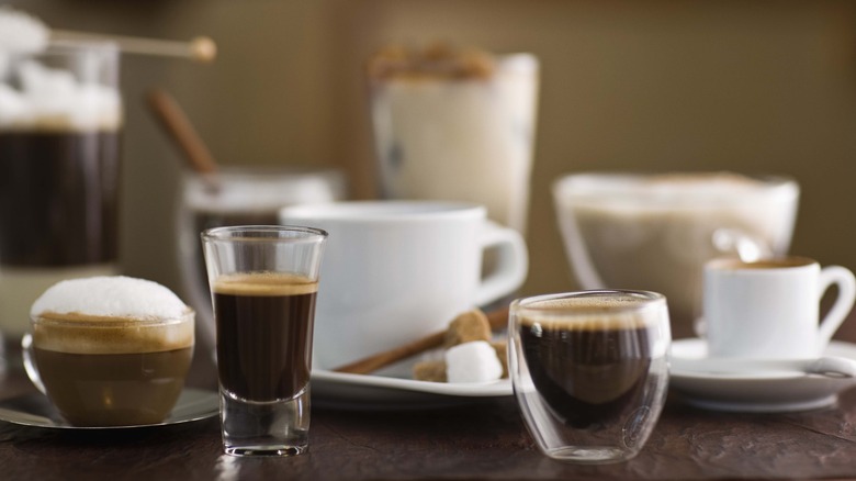 Different coffee drinks on table