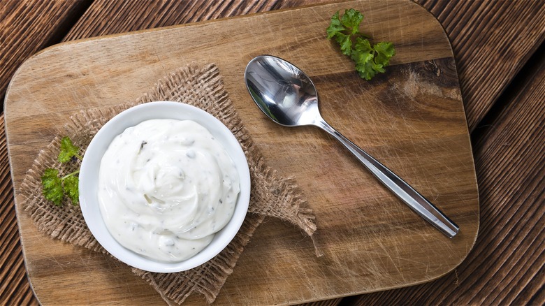 Sour cream herb dip with spoon 