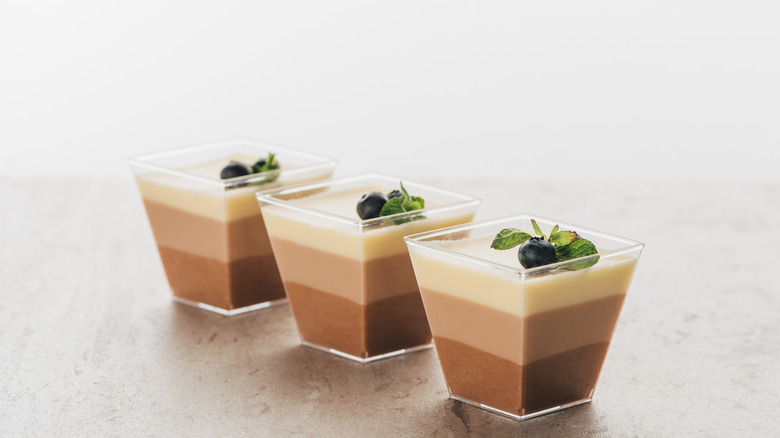 Three glasses of layered chocolate mousse desserts