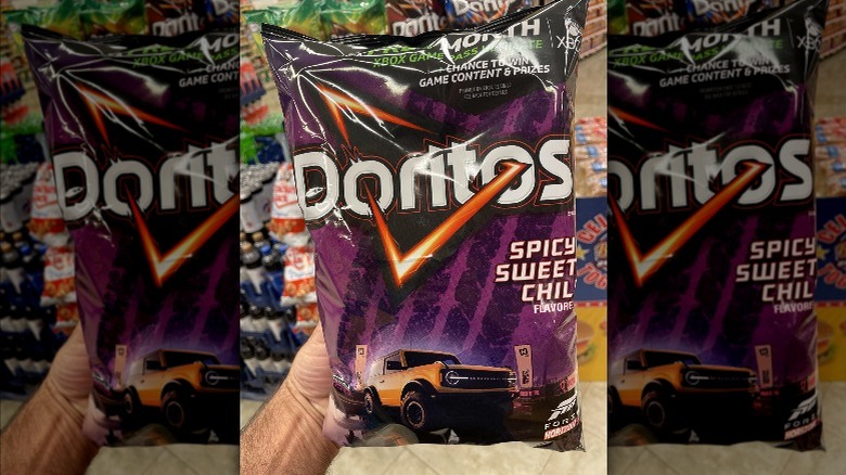 hand holding Doritos bag in store