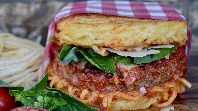 spaghetti bun burger with a coca cola