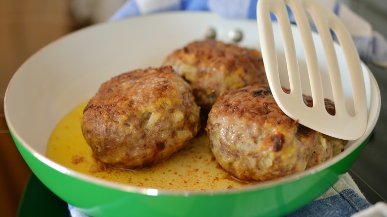Meatballs frying in a pan