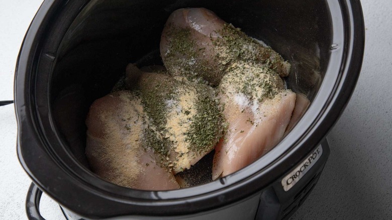 Chicken breasts with seasonings in slow cooker