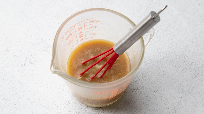 Whisking chicken bouillon paste and stock