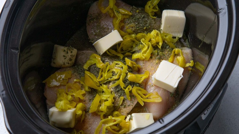 Chicken, stock, pepperoncini, and butter in slow cooker